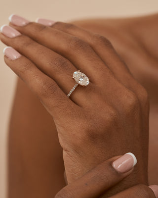 18 Karat Celine Elongated Oval Engagement Ring with Moissanite Center Stone and Diamond Accented Shank